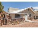 Charming single-story home with a unique stone facade and inviting walkway at 659 D Ave, Boulder City, NV 89005