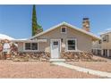 Charming single-story home with a unique stone facade and inviting walkway at 659 D Ave, Boulder City, NV 89005