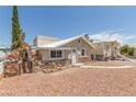 Charming single-story home with a unique stone facade and inviting walkway at 659 D Ave, Boulder City, NV 89005