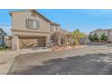Inviting home featuring an attached garage, neutral stucco, and landscaped front yard, on a sunny day at 6804 Tropicaire St, Las Vegas, NV 89149