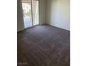 A simple bedroom featuring a large closet and a balcony overlooking the neighborhood at 7469 Margollini St, Las Vegas, NV 89148