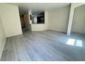 A bright, open-concept living area boasts new flooring and a kitchen view at 7469 Margollini St, Las Vegas, NV 89148