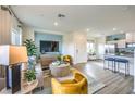 Open-concept living room adjacent to a kitchen, furnished with modern decor, and bathed in natural light at 7925 Pandora Sky St # 392, Las Vegas, NV 89084