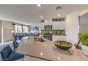 Bright kitchen open to the living area with stainless steel appliances, white cabinets, and modern finishes at 7945 Pandora Sky St # 371, North Las Vegas, NV 89084