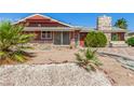 Cozy single-story home featuring desert landscaping, a stone chimney and stone facade accents at 812 Pyramid Dr, Las Vegas, NV 89107
