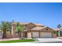 Charming two-story home featuring a desert landscape, tile roof, and a two-car garage at 825 Cornerstone Pl, North Las Vegas, NV 89031