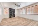 Stylish living room boasts wood-look floors, a modern fireplace, and large windows with natural light at 825 Cornerstone Pl, North Las Vegas, NV 89031