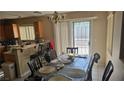 Dining room with a table and chairs, next to kitchen with access to outdoor space at 845 Bladensburg St, Las Vegas, NV 89110