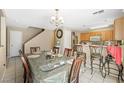 A dining room with a dining table for eight, chandelier, and tiled floor at 845 Bladensburg St, Las Vegas, NV 89110