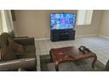 Comfortable living room with tile flooring, sofa and TV at 845 Bladensburg St, Las Vegas, NV 89110