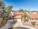Aerial view of the home's red tile roof, desert landscaping, and two car garage at 8932 Beach Front Dr, Las Vegas, NV 89117