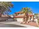 Charming two-story home featuring a well-manicured front yard and a two-car garage at 8932 Beach Front Dr, Las Vegas, NV 89117