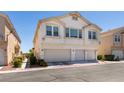 Two-story condo with three-car garage with manicured front yard at 9362 Straw Hays St # 103, Las Vegas, NV 89178