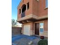 Two-story home with desert landscaping, featuring a garage and a balcony at 9402 Crimson Sky St, Las Vegas, NV 89178