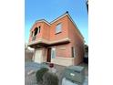 Two-story home with a garage, a balcony, and low maintenance desert landscaping at 9402 Crimson Sky St, Las Vegas, NV 89178