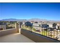 Expansive balcony view overlooking a neighborhood with mountain views in the distance at 9476 Lunar Phase St, Las Vegas, NV 89143