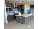 Spacious kitchen features a large island, gray cabinets, and stainless steel appliances at 9476 Lunar Phase St, Las Vegas, NV 89143