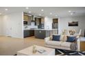 Open-concept living area with modern decor seamlessly blending into a spacious kitchen and dining space at 9476 Lunar Phase St, Las Vegas, NV 89143