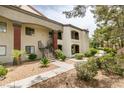 An exterior featuring stucco, brown accents, rock landscaping, and a walkway at 950 Seven Hills Dr # 524, Henderson, NV 89052