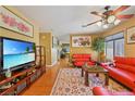 Cozy living room with hardwood floors, a patterned rug, and bright red sofas at 10203 Arlington Abby St, Las Vegas, NV 89183