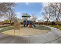 Community playground offering a fun and safe play area for children with mature trees at 10373 Northern Hills Ave, Las Vegas, NV 89166