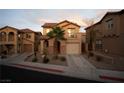Beautiful two-story home boasts a private balcony, desert landscaping, and convenient garage access at 1136 Paradise Garden Dr, Henderson, NV 89002