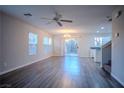 Spacious living area with modern flooring, abundant natural light, ceiling fan, and a stylish chandelier at 1136 Paradise Garden Dr, Henderson, NV 89002