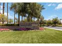 Stone entrance sign to Rhodes Ranch community, surrounded by lush landscaping and flowers at 174 Augusta Course Ave, Las Vegas, NV 89148