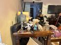 View of living room with clutter on a table, revealing the interior of the property at 1955 Raindance Way, Las Vegas, NV 89169