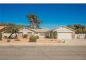 Charming single-story home with desert landscaping and a two-car garage, showcasing its inviting curb appeal at 2004 Canterbury Dr Dr, Las Vegas, NV 89119