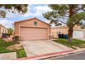 Single-story home with a two-car garage and desert landscaping at 2104 Kendall Hill Ave, Las Vegas, NV 89106