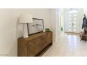 Inviting entryway features a stylish wood console table, bright lighting, and a welcoming ambiance at 211 E Kimberly Dr, Henderson, NV 89015