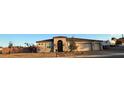 Single-story home with desert landscaping, stone accents, and a three-car garage at 211 E Kimberly Dr, Henderson, NV 89015