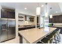 Bright kitchen with a spacious island, stainless steel appliances, and dark wood cabinets for a modern look at 211 E Kimberly Dr, Henderson, NV 89015