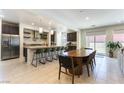 Open-concept kitchen with a large island, modern appliances, and adjacent dining area, great for entertaining at 211 E Kimberly Dr, Henderson, NV 89015