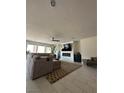 Spacious living room with tile floors, large sectional sofa, and a sleek fireplace at 211 E Kimberly Dr, Henderson, NV 89015