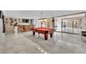Recreation room with a pool table, a bar with seating, and marble flooring at 2131 Diamond Bar Dr, Las Vegas, NV 89117