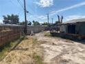 View of the backyard surrounded by wooden and concrete fencing at 2642 San Vincente Ct, Las Vegas, NV 89115