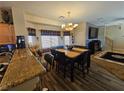 Inviting dining room with stylish chandelier, comfortable seating, and modern decor at 2691 Benton Cove St, Laughlin, NV 89029