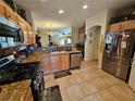 Spacious kitchen featuring stainless steel appliances, granite counters, and an open layout at 2691 Benton Cove St, Laughlin, NV 89029