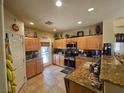 Well-lit kitchen with granite countertops, stainless steel appliances, and light wood cabinets at 2691 Benton Cove St, Laughlin, NV 89029