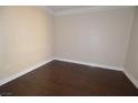 Cozy bedroom featuring neutral walls, white trim, and a dark hardwood floor at 270 E Flamingo Rd # 107, Las Vegas, NV 89169