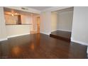 Open-concept living room with dark hardwood floors and easy access to other rooms at 270 E Flamingo Rd # 107, Las Vegas, NV 89169
