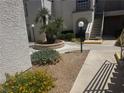 Beautiful courtyard features palm trees, flowering bushes, and pathways providing tranquil ambiance at 3150 Soft Breezes Dr # 1040, Las Vegas, NV 89128