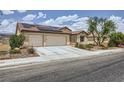 Single-story home with desert landscaping, driveway, tile roof, and solar panels at 3220 W Hammer Ln, North Las Vegas, NV 89031