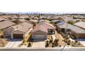 Bird's eye view of home with desert landscaping, solar panels, and convenient two-car garage at 3621 Jasmine Heights Ave, North Las Vegas, NV 89081