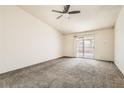 This spacious bedroom features a ceiling fan and sliding glass door at 4611 Four Leaf Clover Dr, Las Vegas, NV 89122