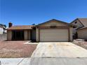 Single-story home featuring a two-car garage and low maintenance landscaping at 4766 Knollwood Dr, Las Vegas, NV 89147