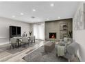 Staged living room with modern furniture, fireplace, and lots of natural light at 4813 Plata Del Sol, Las Vegas, NV 89121