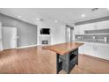 Open concept living area with fireplace and eat-in kitchen featuring a functional island at 5012 Newport Cove Dr # C, Las Vegas, NV 89119